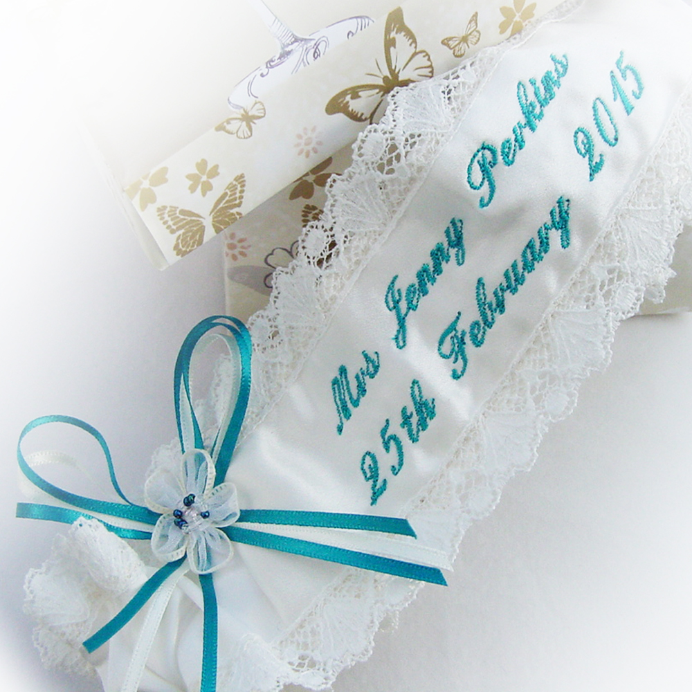 The bride chose a rich teal script for her garter