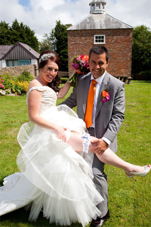 Claire and her new hubby showing off her custom made football garter