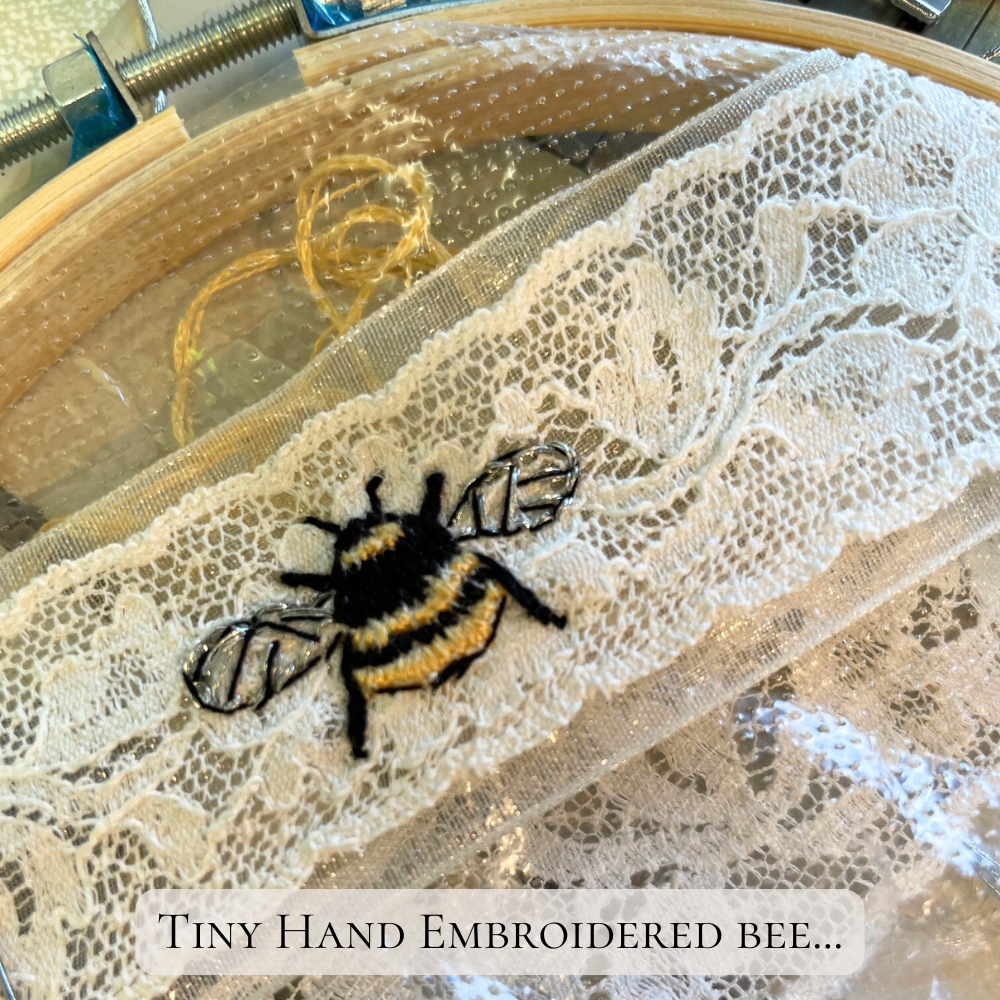 Hand embroidered bee on soft cotton Nottingham lace